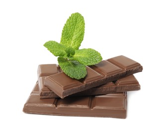 Photo of Tasty milk chocolate pieces with mint on white background