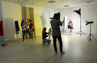 Photo studio with professional equipment and team of workers