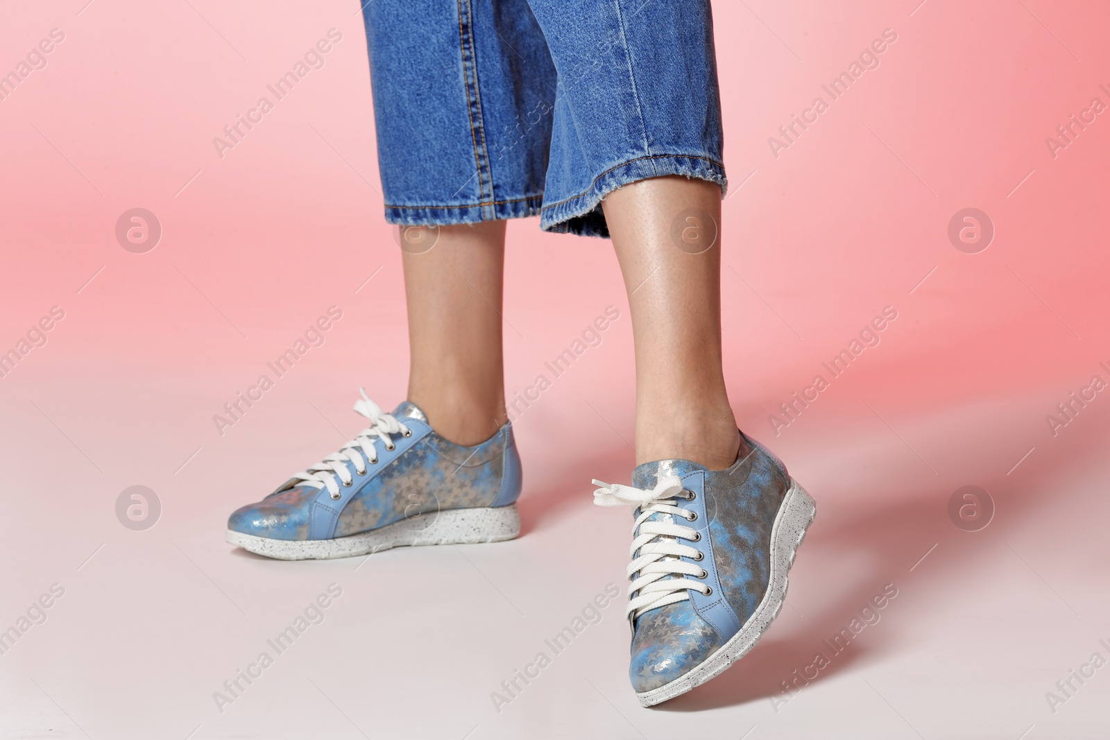 Photo of Woman in stylish shoes on color background, closeup