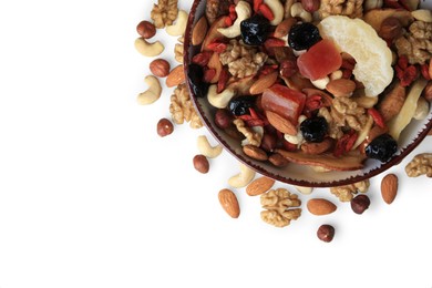 Bowl with mixed dried fruits and nuts on white background, top view