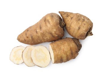 Photo of Whole and cut turnip rooted chervil tubers isolated on white, top view