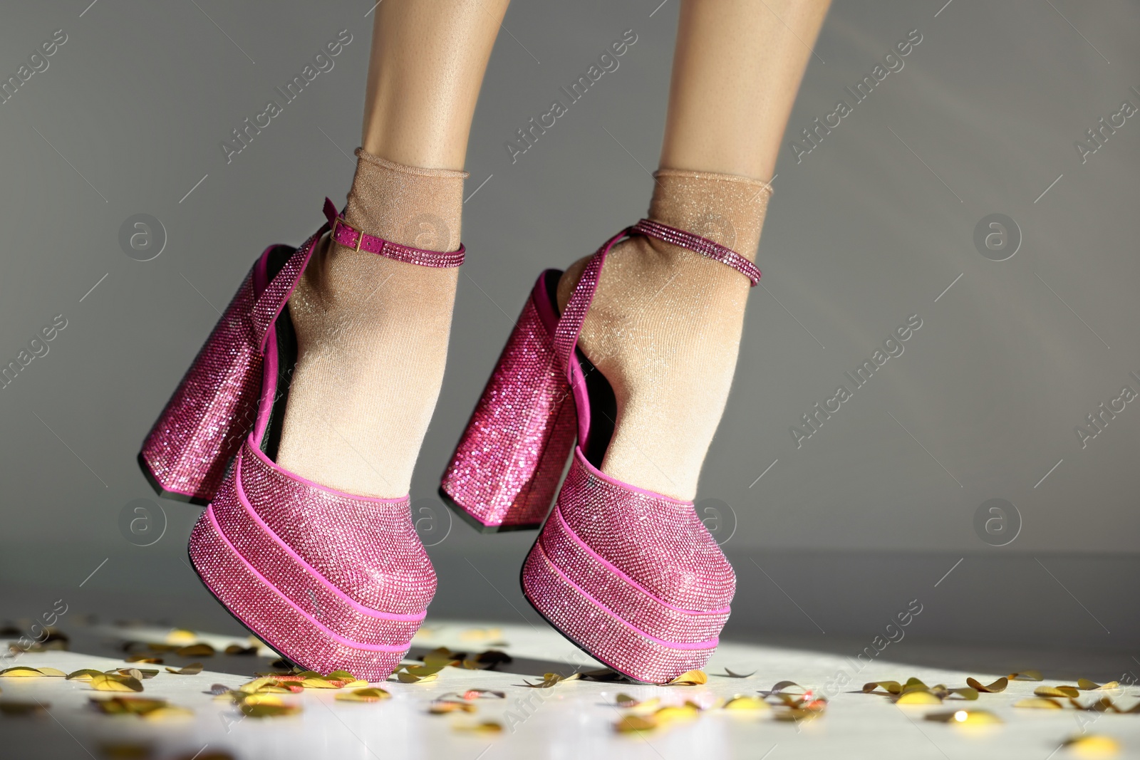 Photo of Stylish party. Woman wearing pink high heeled shoes with platform and square toes indoors, closeup