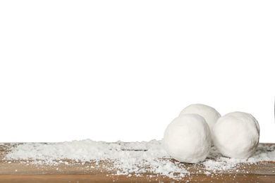 Snowballs on wooden table against white background. Space for text