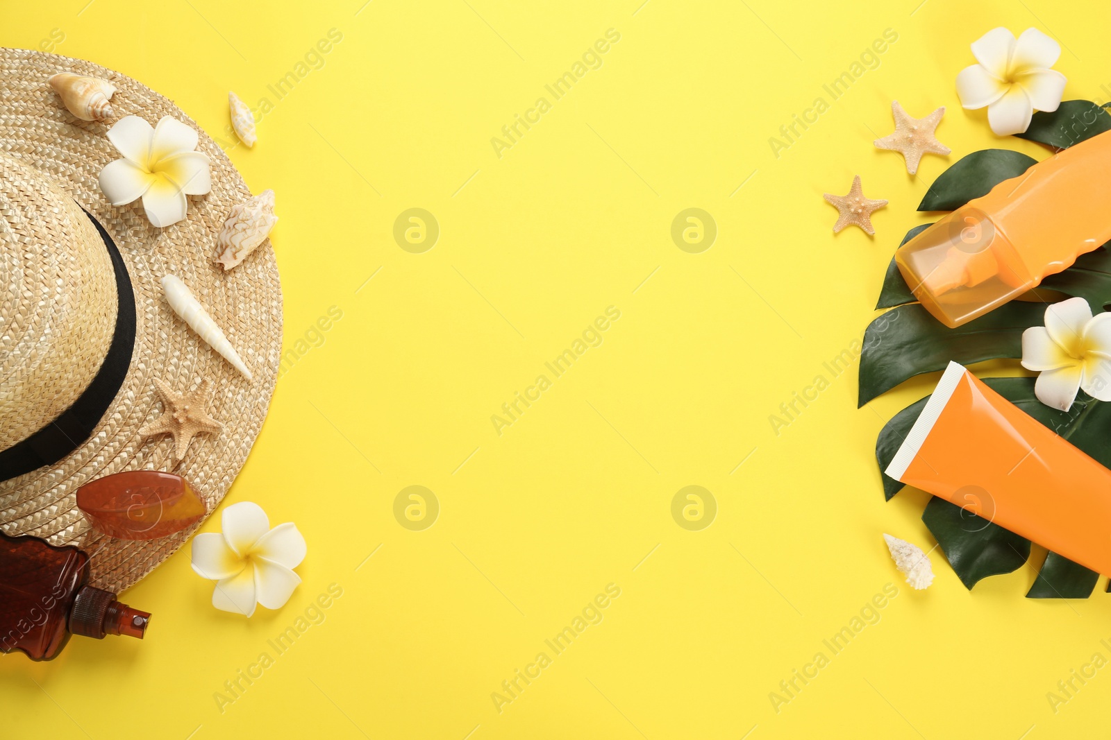 Photo of Sun protection products and beach accessories on yellow background, flat lay. Space for text