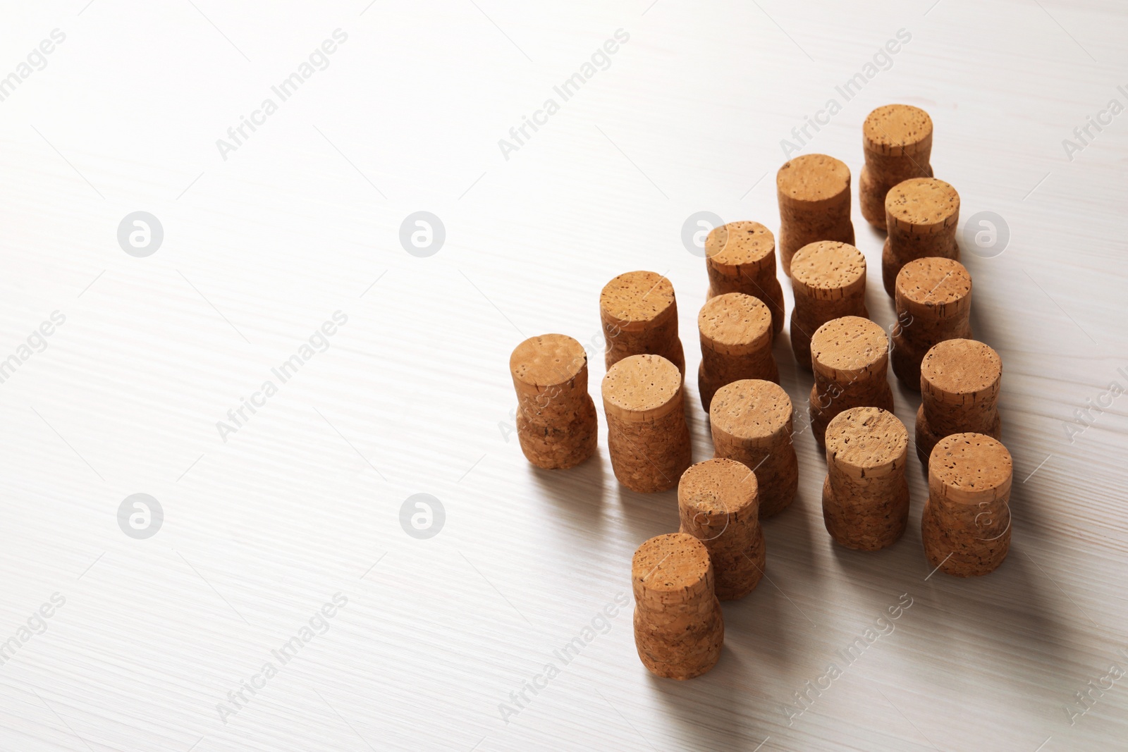 Photo of Christmas tree made of wine corks on white wooden table. Space for text