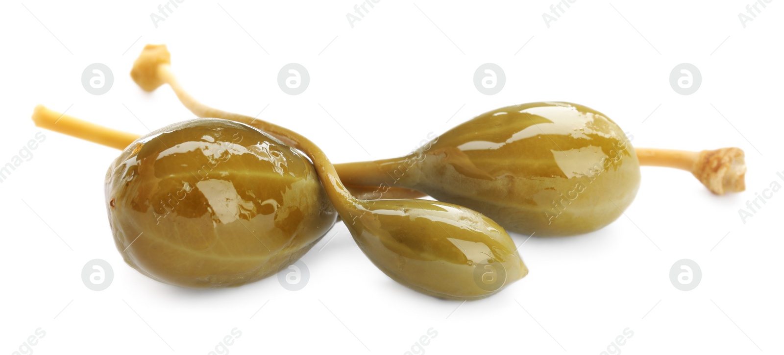 Photo of Three delicious pickled capers on white background