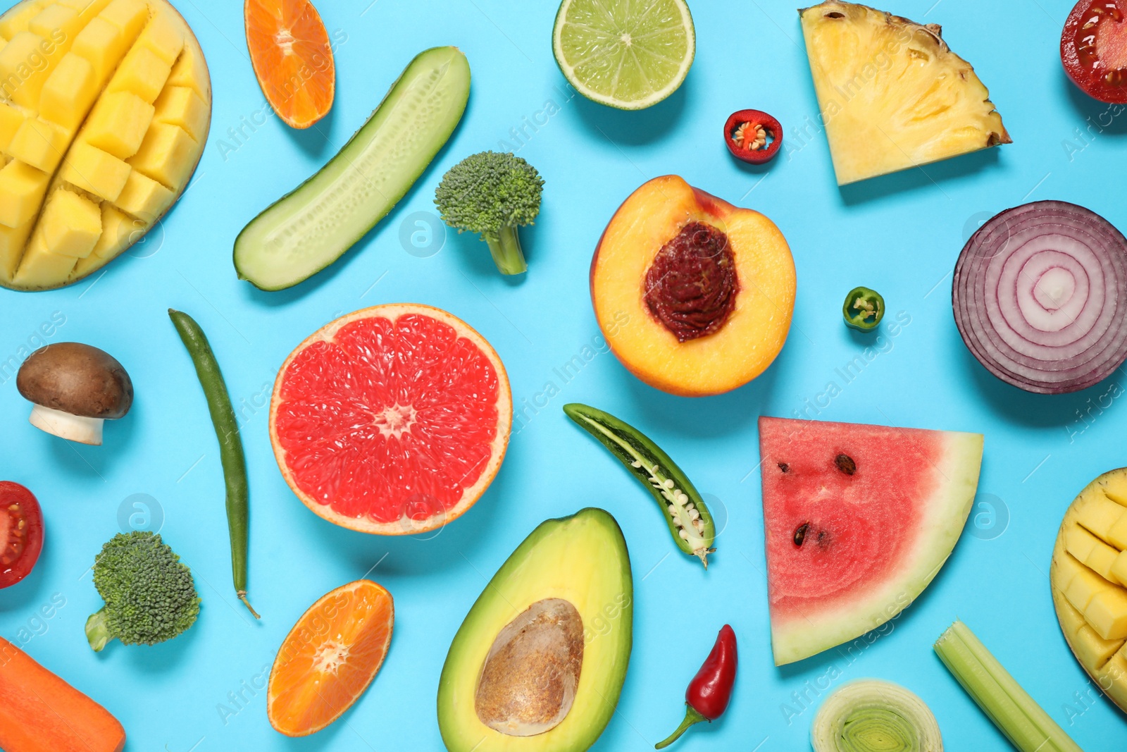 Photo of Flat lay composition with fresh organic fruits and vegetables on light blue background