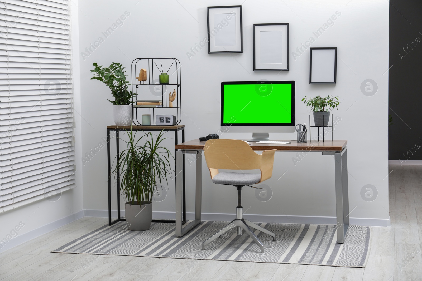 Image of Computer display with chroma key on desk in room. Comfortable workplace