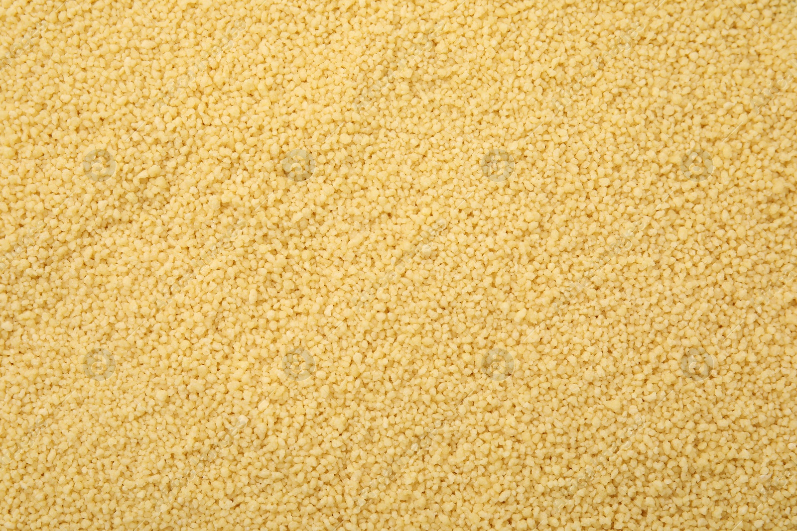 Photo of Uncooked organic couscous as background, top view