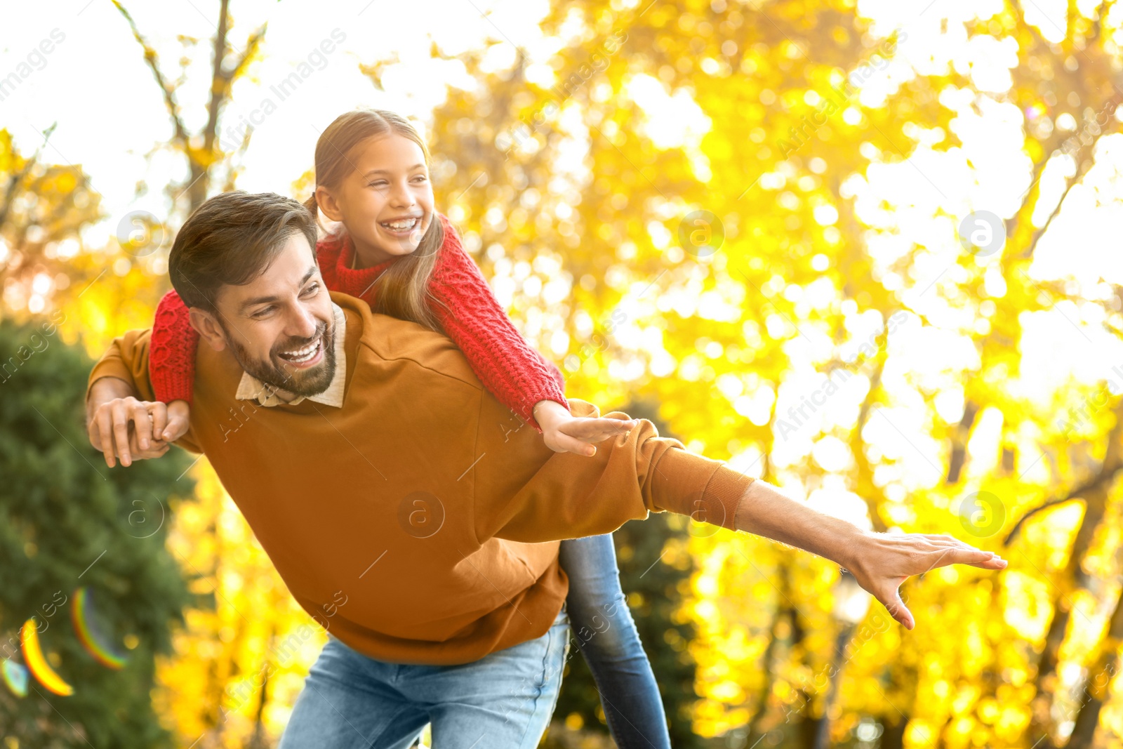 Photo of Happy father and daughter spending time in park. Autumn walk