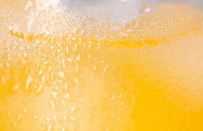 Photo of Glass of refreshing drink with ice cubes as background, closeup