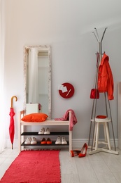 Photo of Cozy stylish hallway interior with shoe rack and mirror. Home design idea