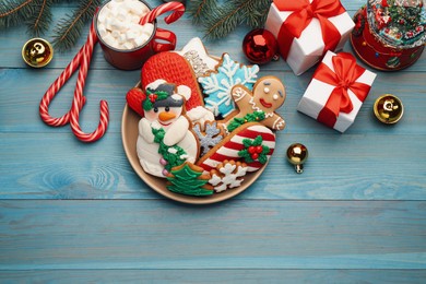 Flat lay composition with delicious homemade Christmas cookies on turquoise wooden table. Space for text