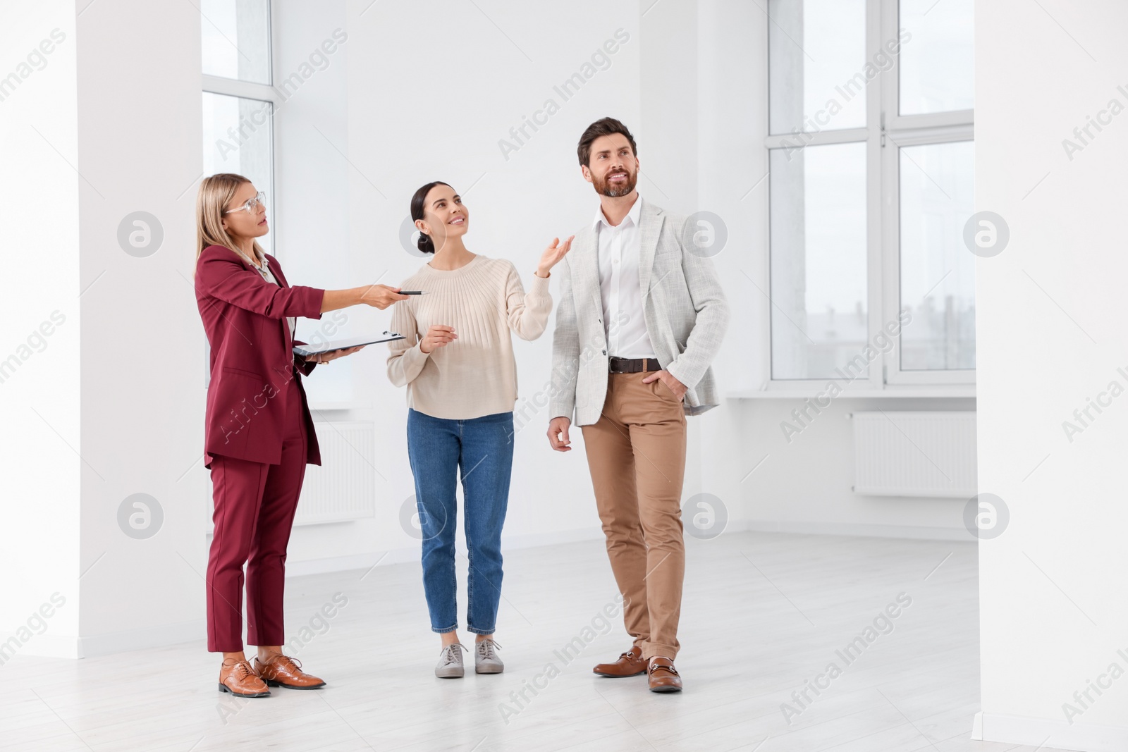 Photo of Real estate agent showing new apartment to couple