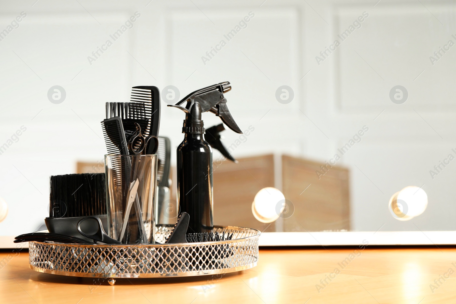 Photo of Set of hairdresser tools on table in salon. Space for text