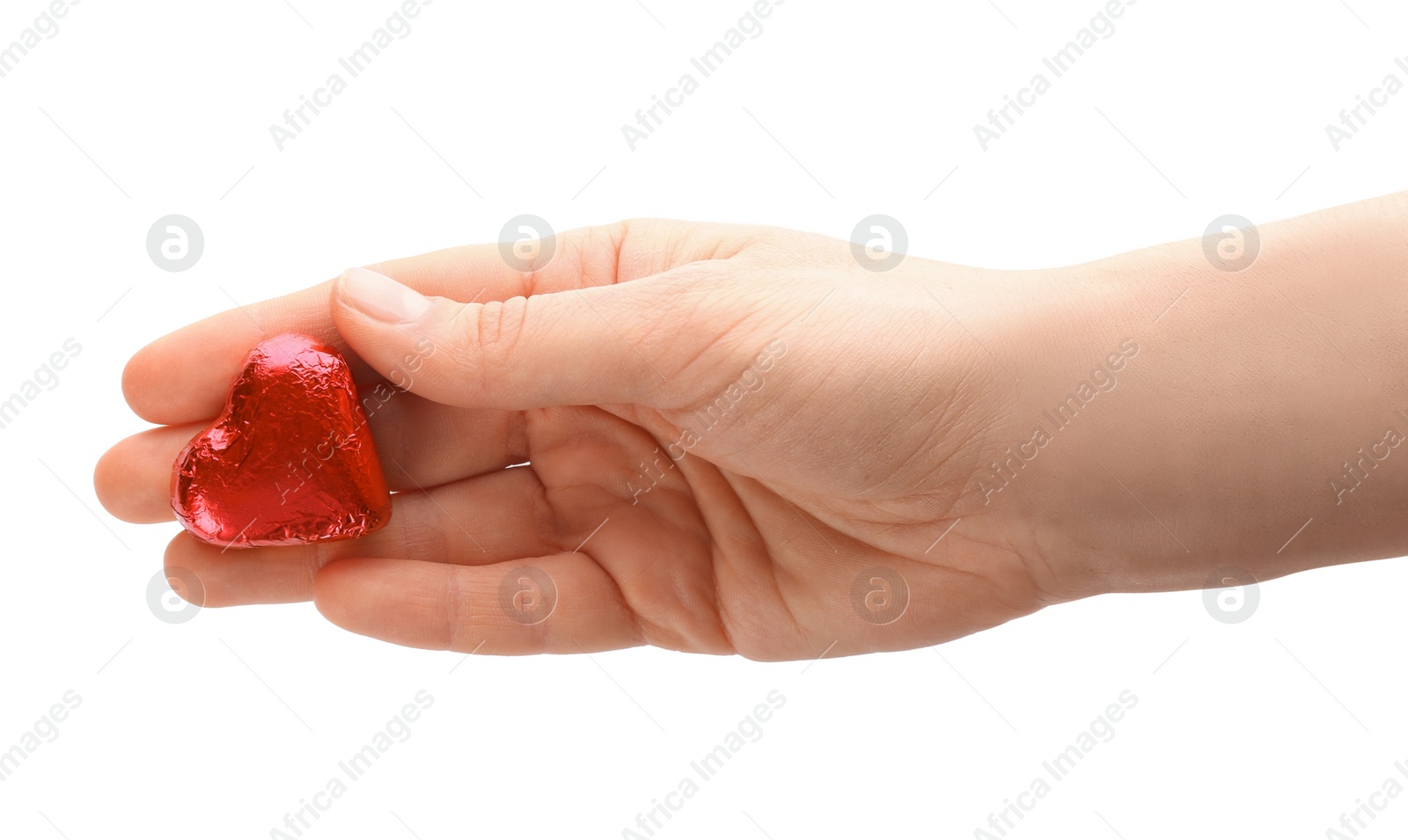 Photo of Woman holding heart shaped chocolate candy on white background, closeup