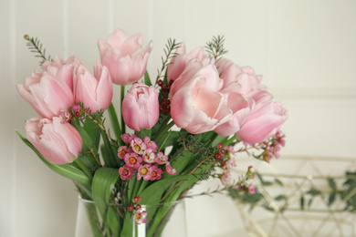 Photo of Beautiful bouquet with spring pink tulips on light background