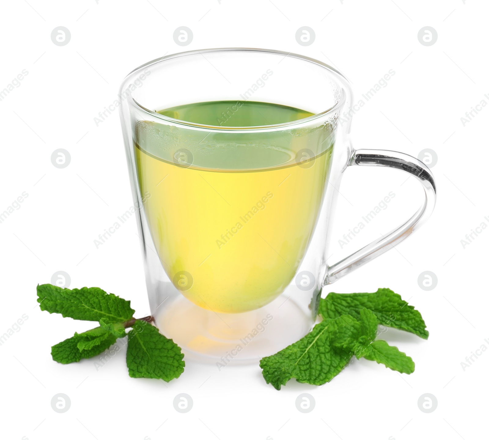 Photo of Fresh green tea in glass mug and mint isolated on white