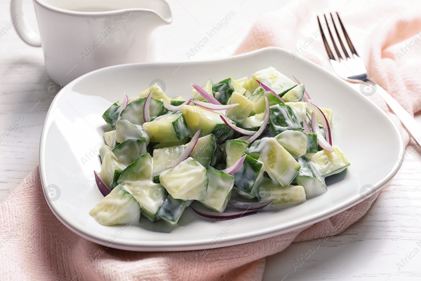 Photo of Plate with fresh creamy cucumber salad served on table