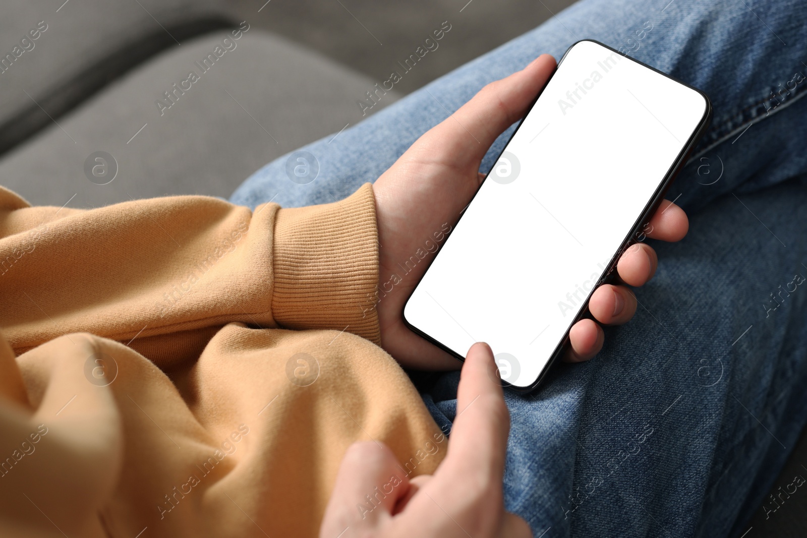 Photo of Man using smartphone with blank screen indoors, closeup. Mockup for design