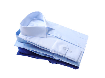 Photo of Stack of stylish shirts isolated on white. Dry-cleaning service