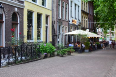 Photo of Blurred view of city street with beautiful buildings