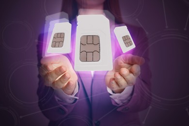 Image of  Woman demonstrating SIM cards of different sizes on color background, closeup 