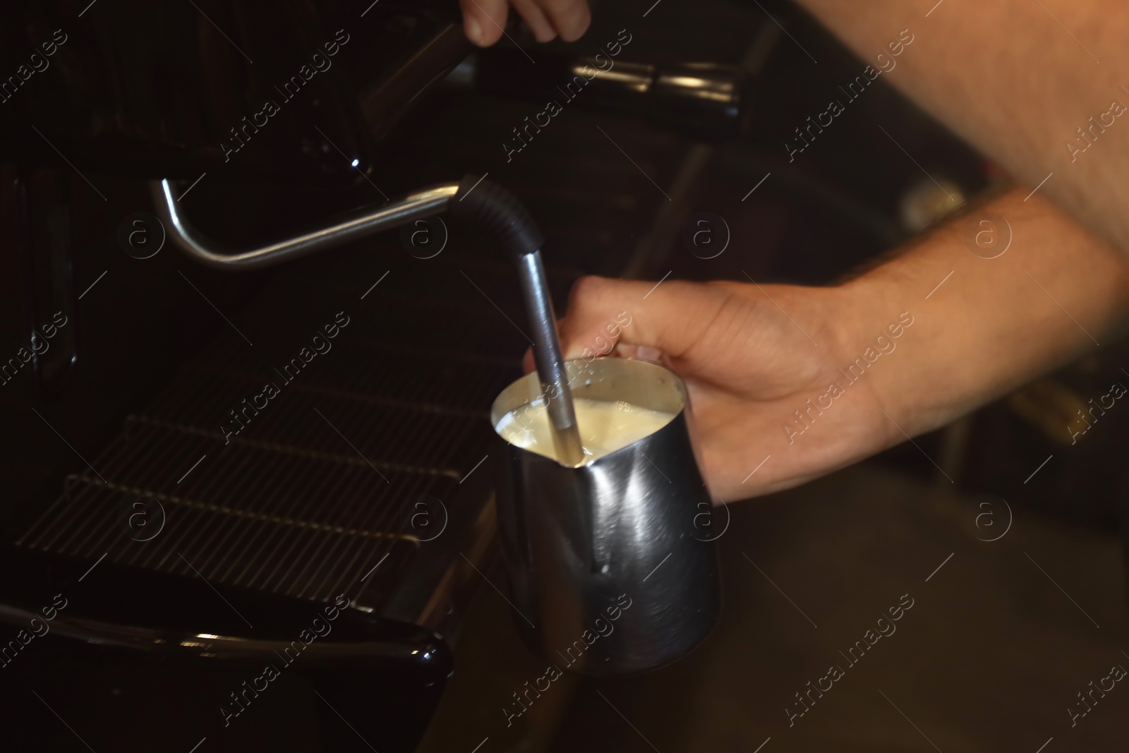 Photo of Barista preparing fresh aromatic coffee on modern machine, closeup