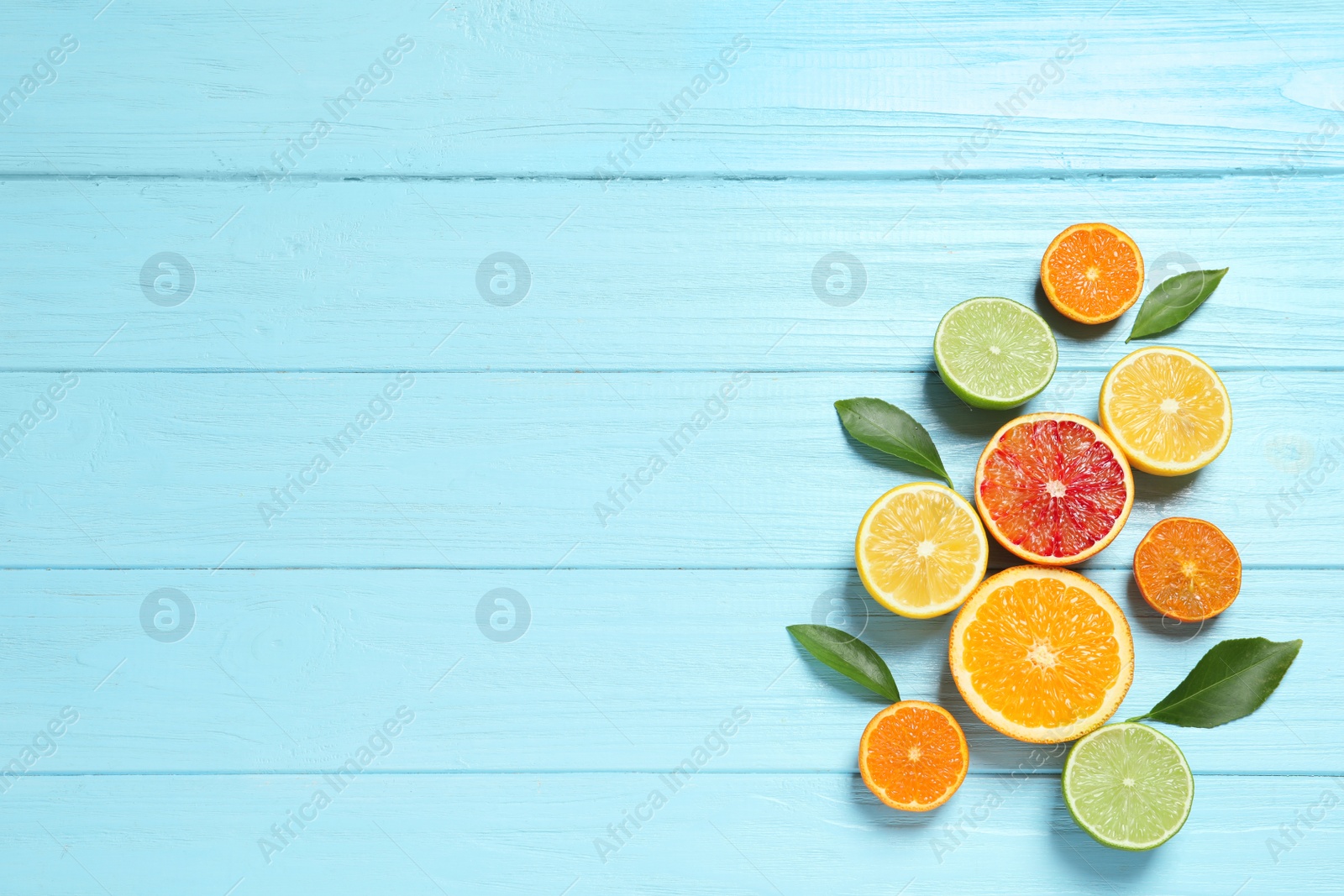 Photo of Flat lay composition with different citrus fruits and space for text on wooden background