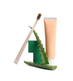 Photo of Tube of toothpaste, brush and aloe vera leaves on white background