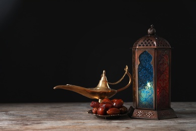 Photo of Composition with Muslim lamp on wooden table. Fanous as Ramadan symbol