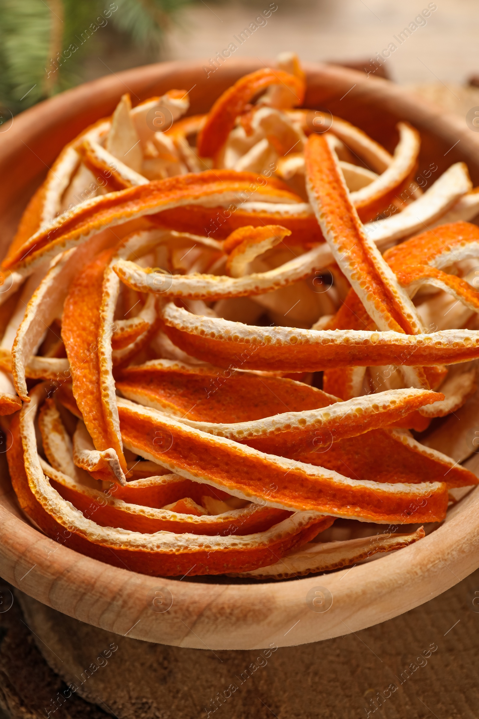 Photo of Dry orange peels on wooden table, closeup