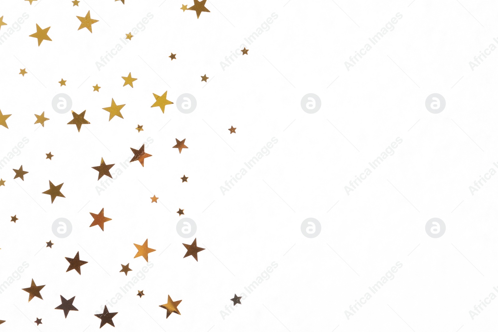 Photo of Star shaped golden confetti on white background, top view