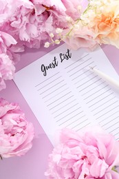 Guest list, pen and beautiful flowers on violet background, flat lay. Space for text