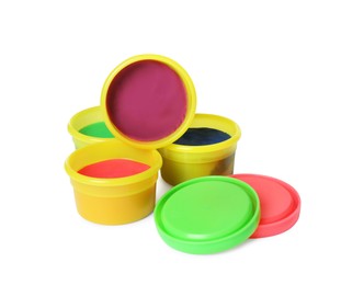 Plastic containers with colorful play dough on white background