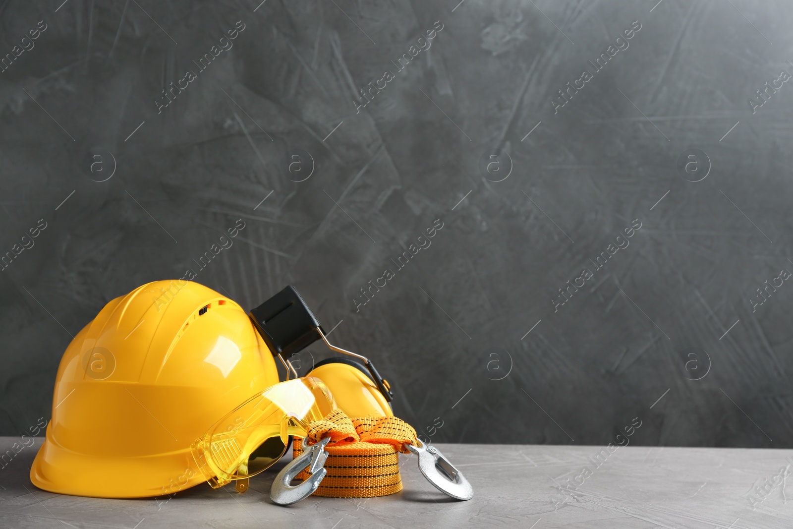Photo of Composition with safety equipment on table against grey background. Space for text