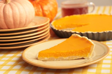 Photo of Plate with piece of fresh homemade pumpkin pie on table