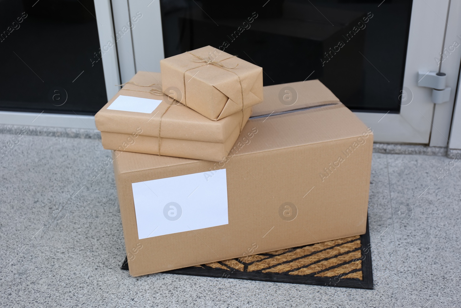 Photo of Delivered parcels on door mat near entrance