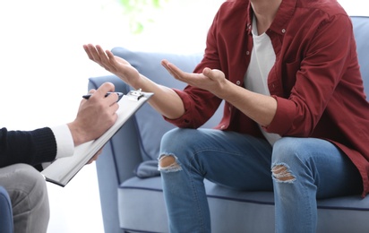 Photo of Young man with problems at psychologist office