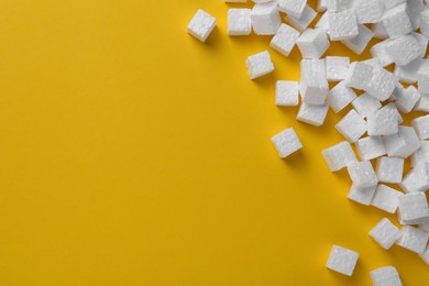 Photo of Many styrofoam cubes on yellow background, flat lay. Space for text