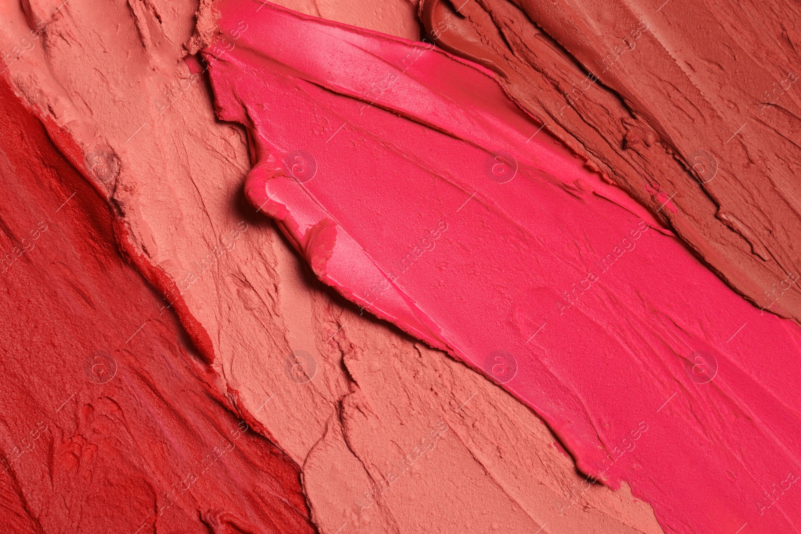 Photo of Texture of beautiful lipsticks as background, top view