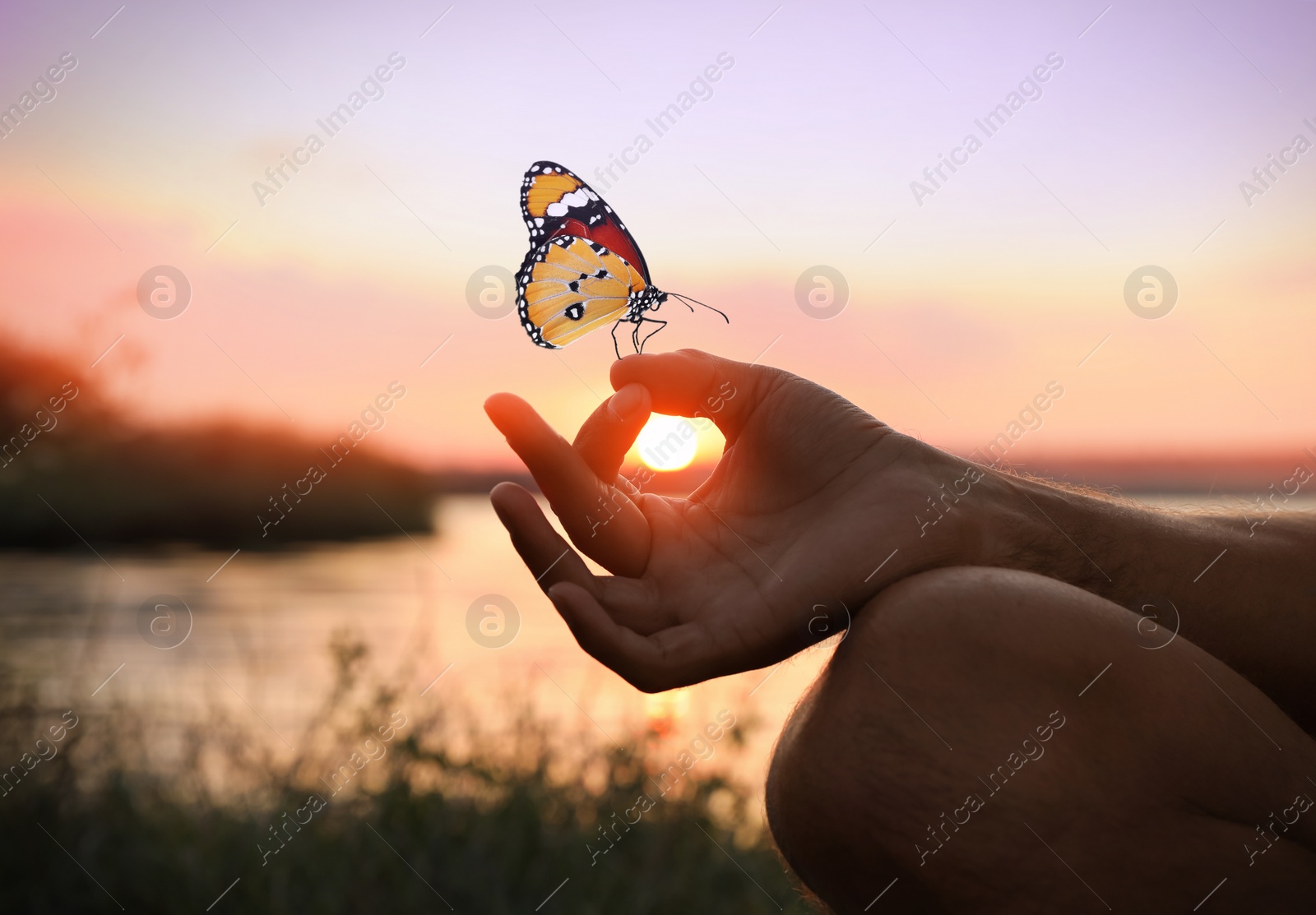 Image of Man meditating near river at sunset, closeup. Space for text