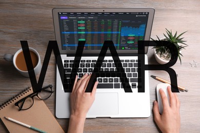 Image of Influence of war on stock exchange. Woman analyzing electronic trading platform on laptop at wooden table, top view