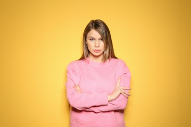 Portrait of beautiful young woman on color background