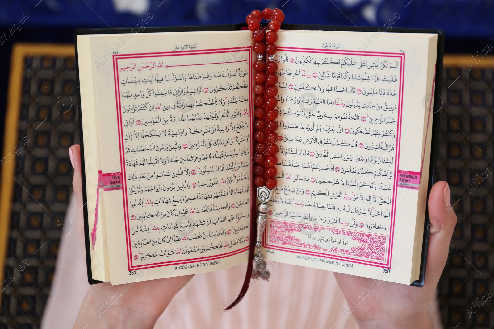 Photo of Muslim woman reading Koran indoors, top view