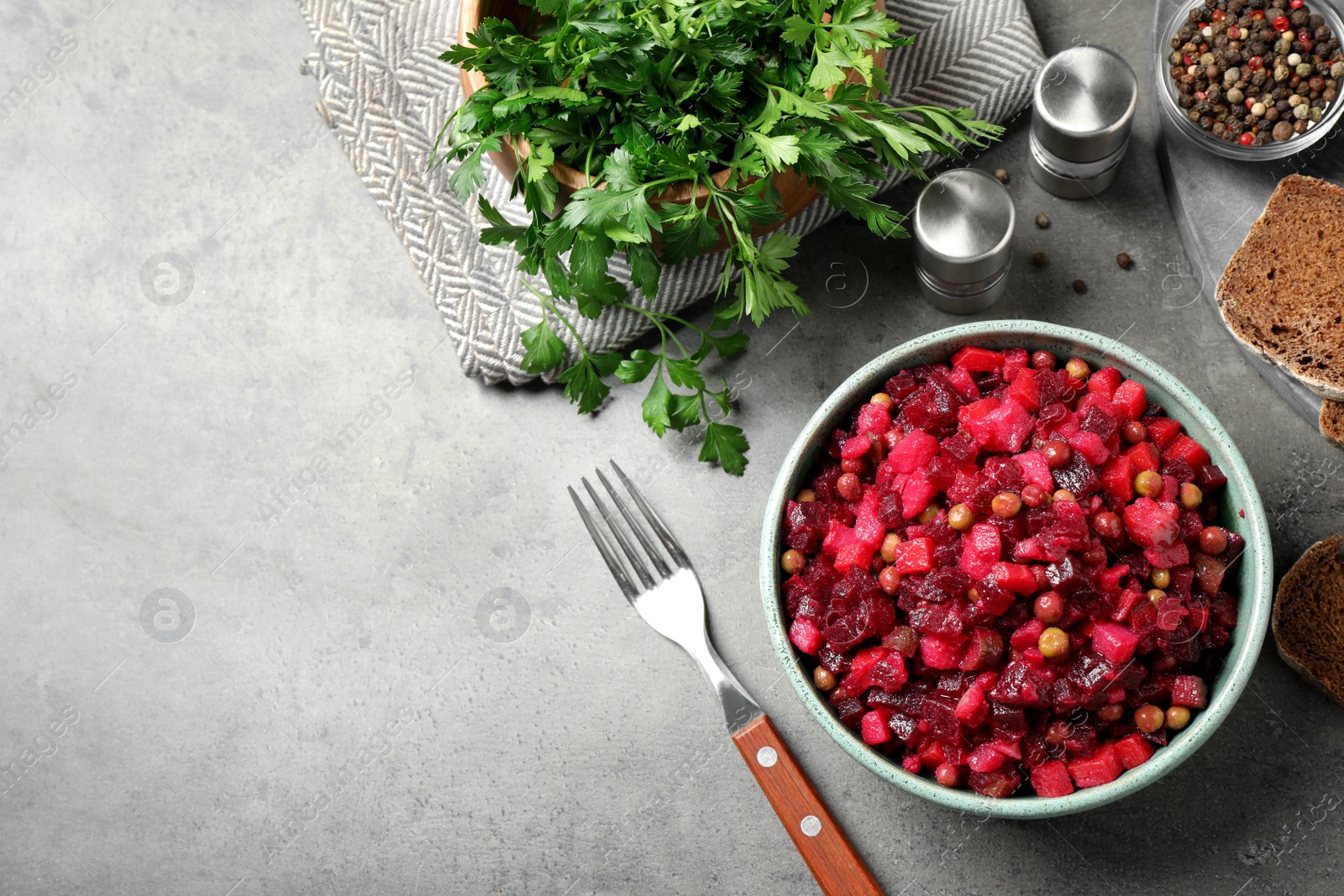 Photo of Traditional Russian salad vinaigrette served on grey table, flat lay. Space for text