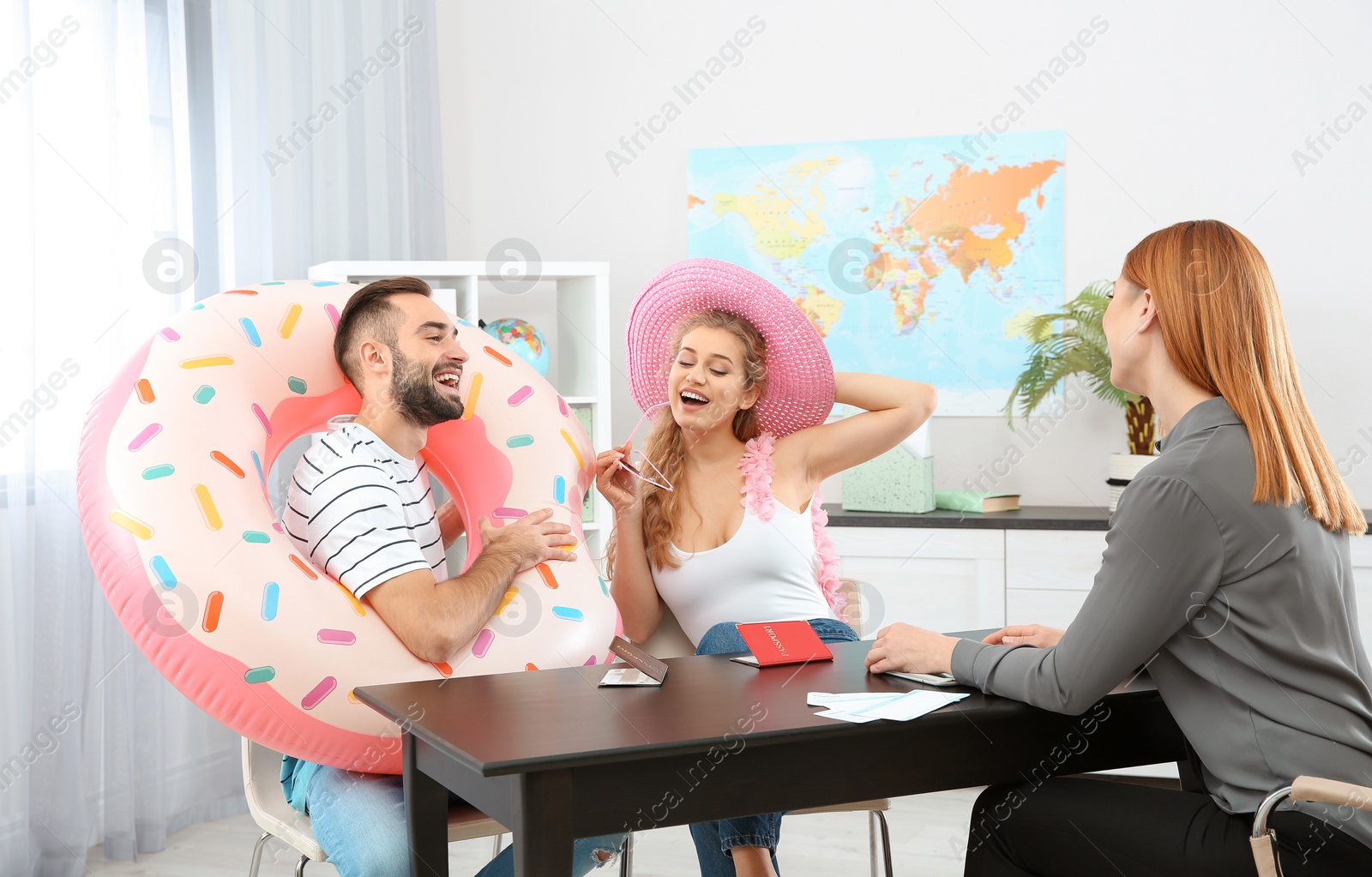 Photo of Beautiful young couple visiting travel agency office