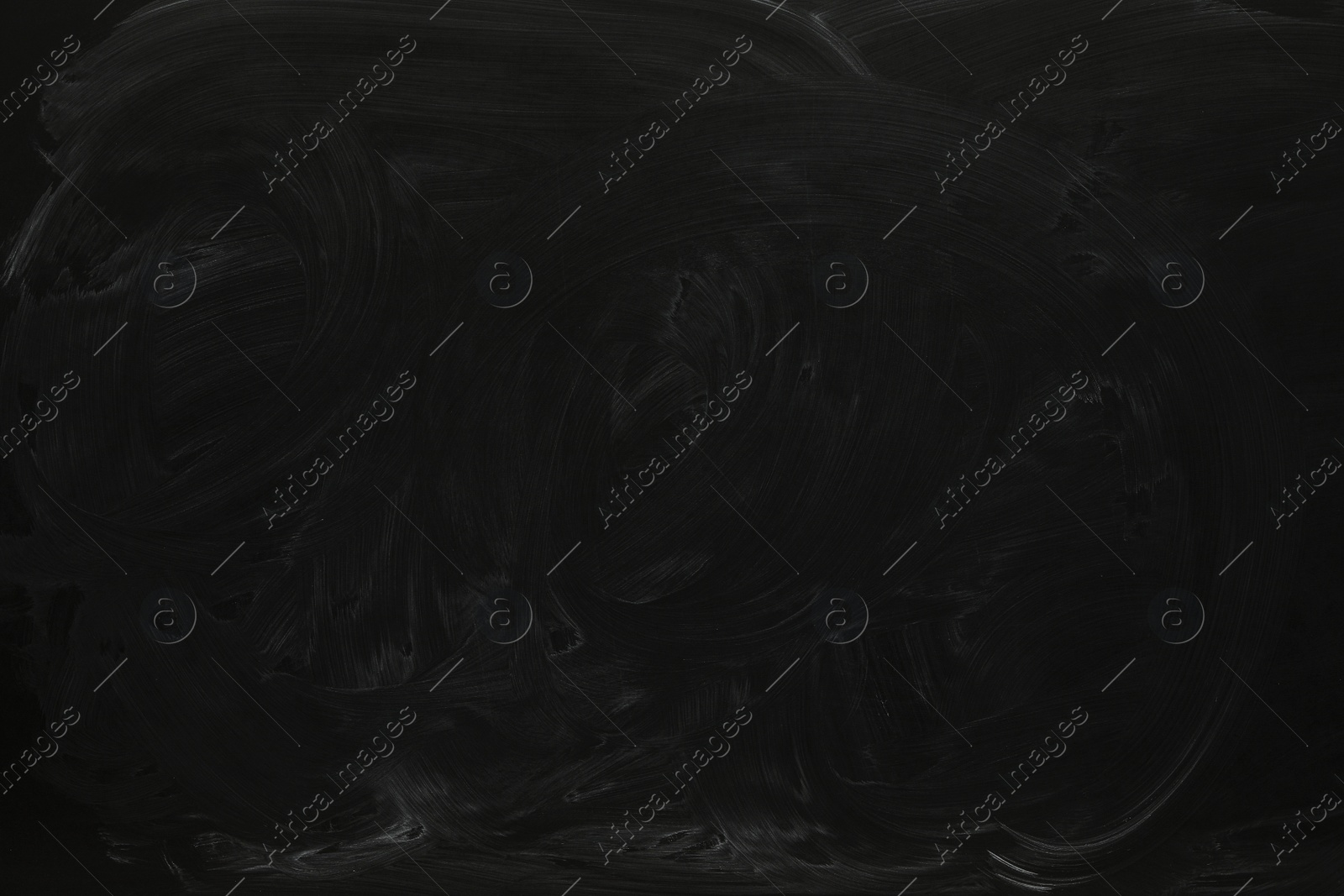 Photo of Chalk rubbed out on black chalkboard as background, closeup. Space for text