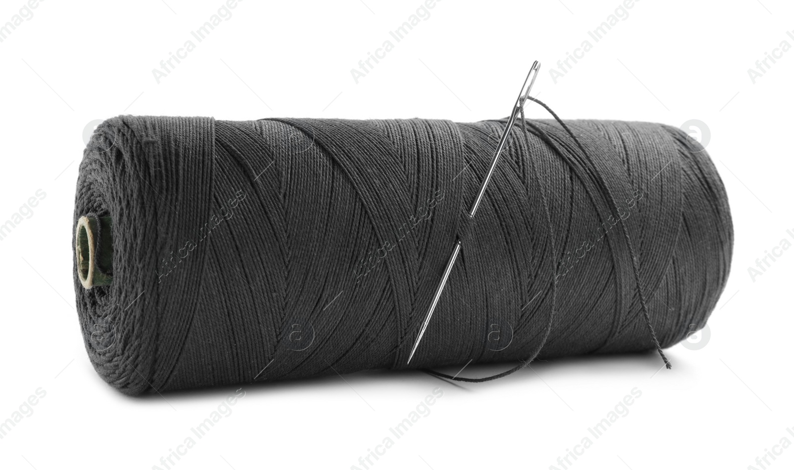 Photo of Black sewing thread with needle on white background