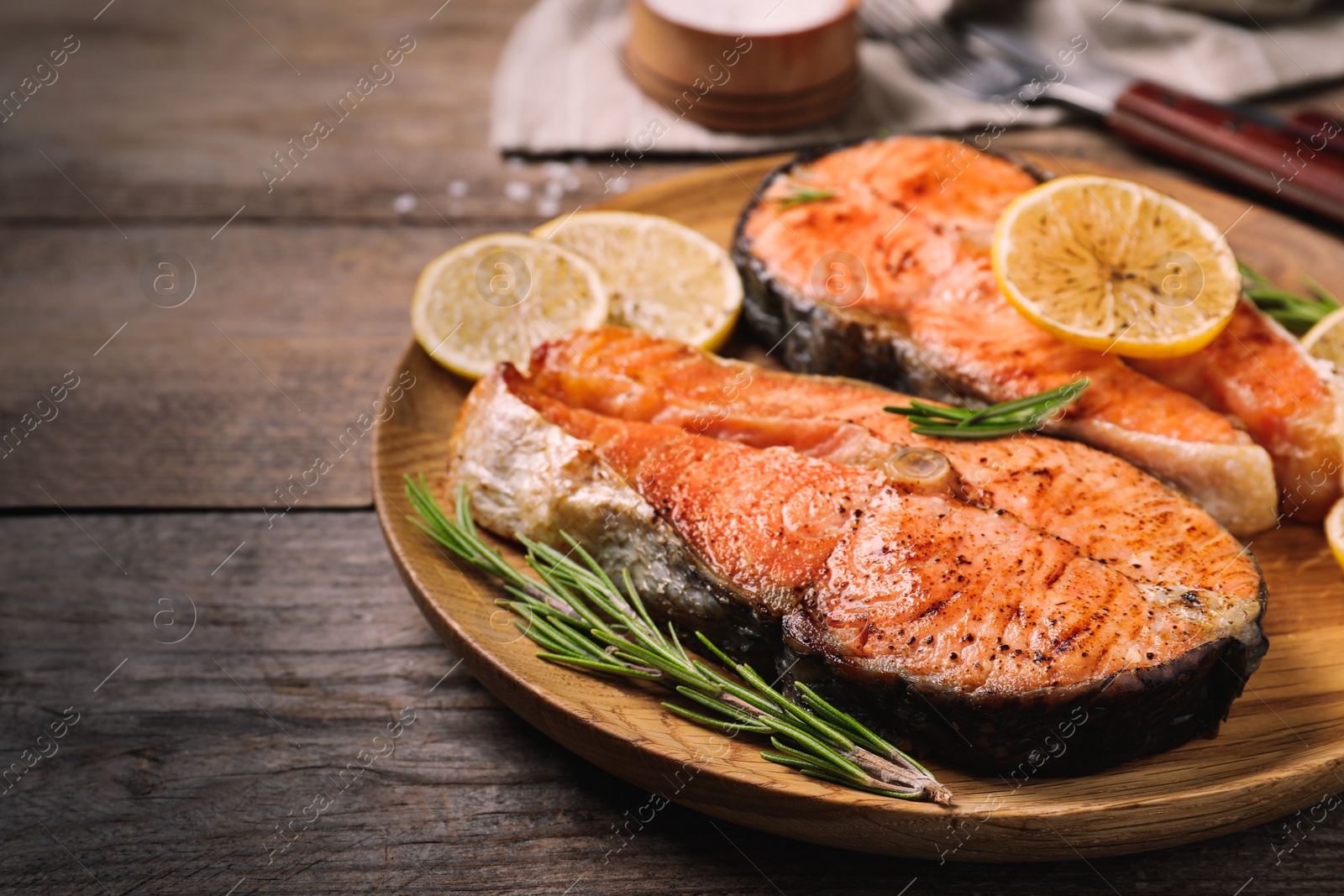 Image of Tasty cooked red fish on wooden table, closeup. Food photography  